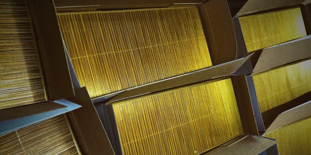 brass metal tags in cardboard boxes