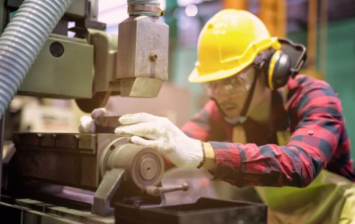 A young worker using machinery. Machinery tags is not only important for identification but also important for safety when using different machineries.
